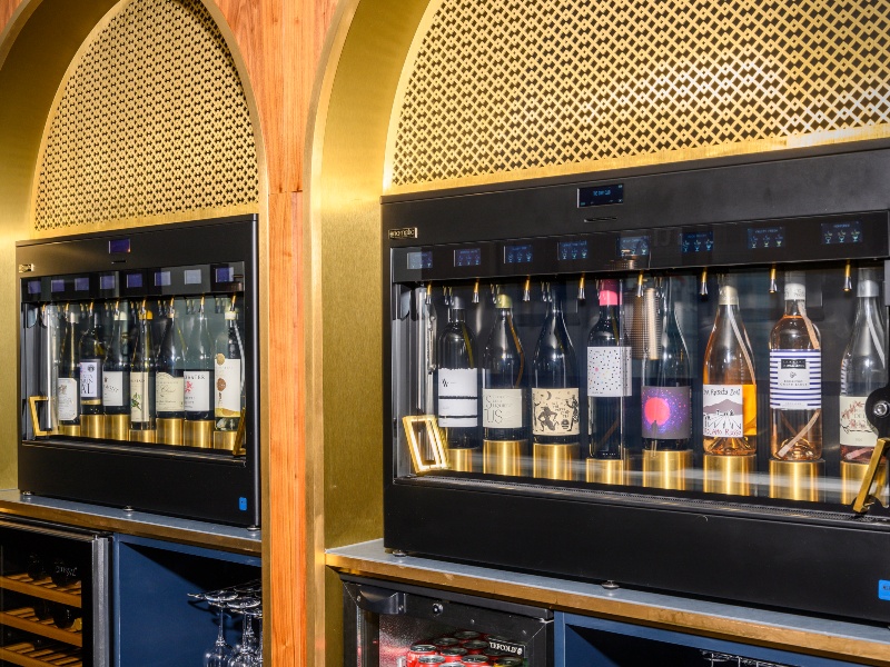 Interior photo of bar area with bottles of alcoholic drinks in two glass cabinets