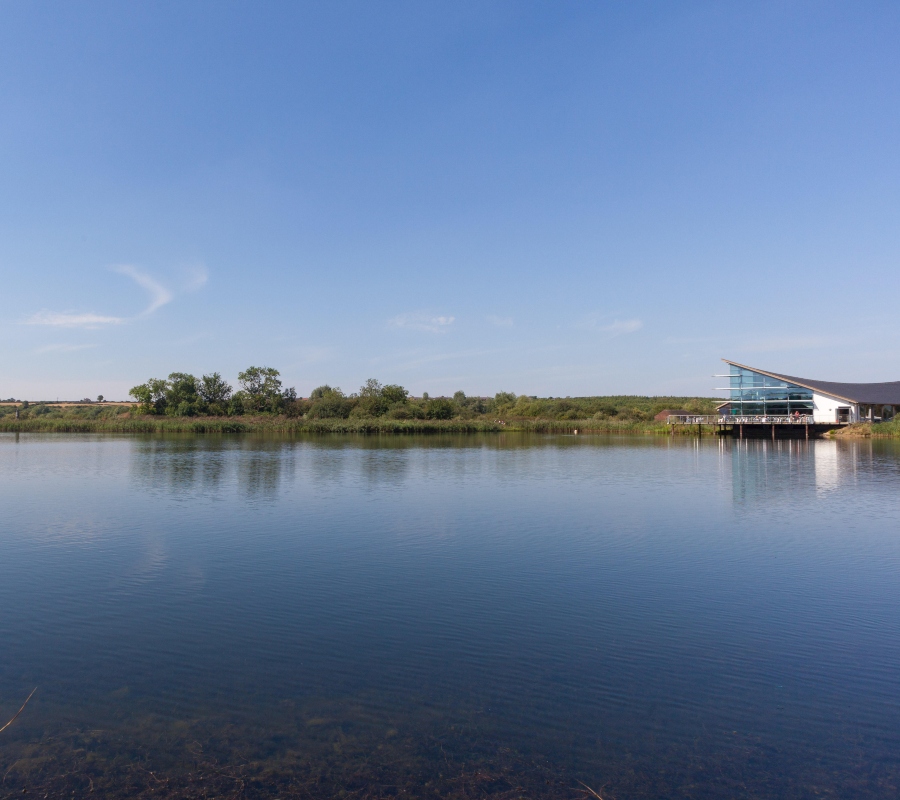 Exterior view across Stanwick lake with building on the bank