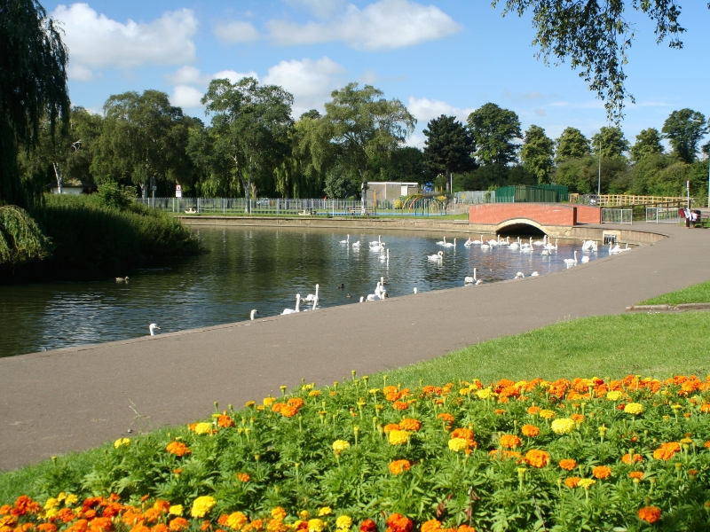 The Embankment in Wellinborough with ducks on a lake and colourful flowers