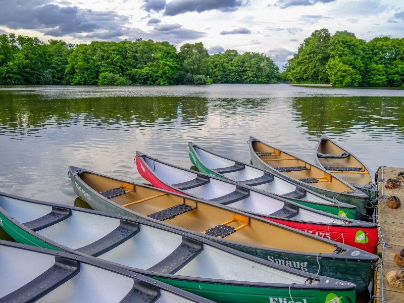Exterior photo of several colourful canoes on Salhouse Broads, Norwich, Norfolk