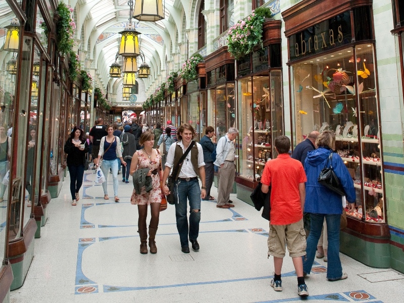 Photo of shoppers and shops in the indoor Royal Arcade Norwich Norfolk