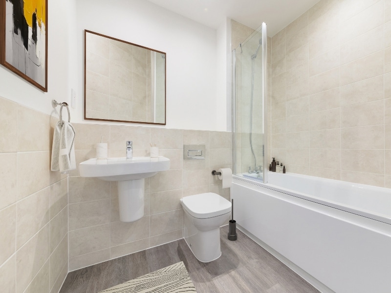 Image is a CGI representation of the bathroom in the actual Plot 22, One Bed Shared Ownership Apartment at Woodside Grove, Bagshot, from Legal & General Affordable Homes