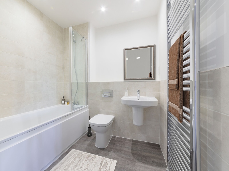 Image is a CGI representation of the bathroom in the actual Plot 24, Two Bed Shared Ownership Apartment at Woodside Grove, Bagshot, from Legal & General Affordable Homes