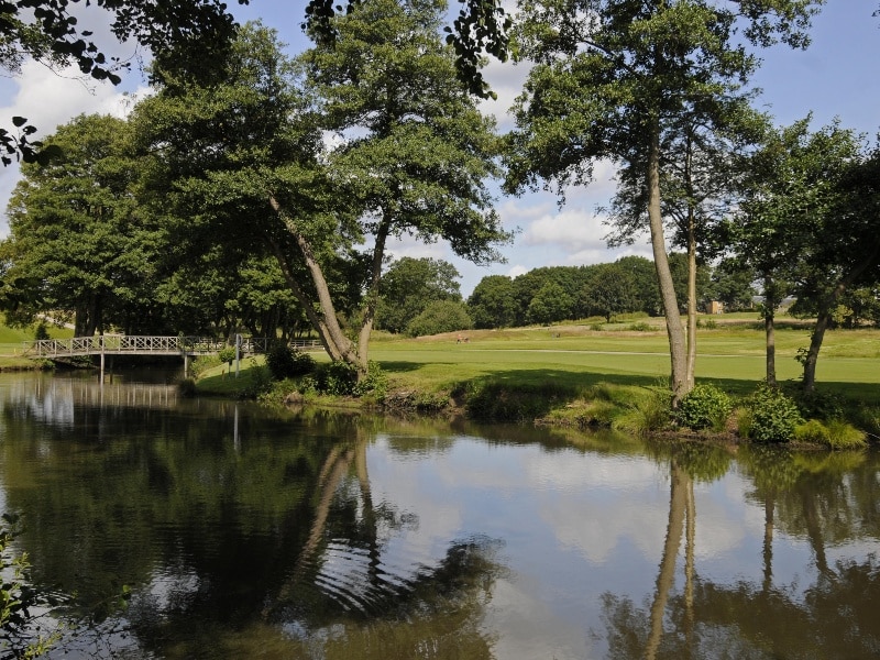 Photo of a lake, with trees and views of the Windlesham Golf Club