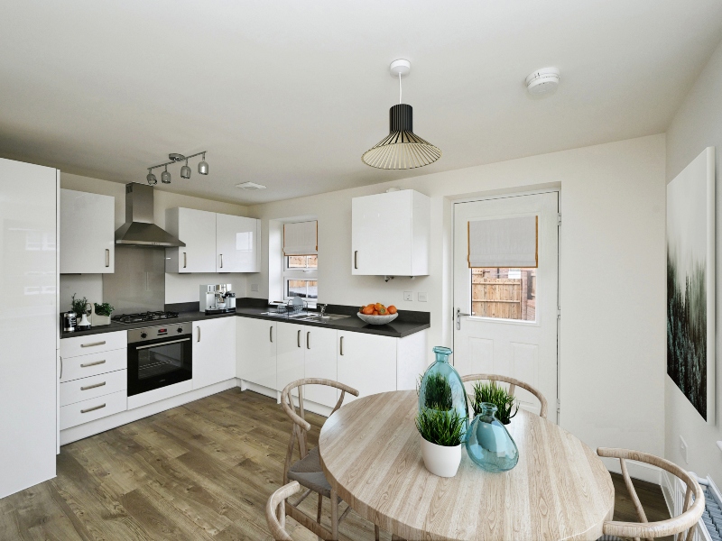 Interior kitchen of a three bedroom house showing a round dining table ,cooker and sink, Meden Meadows