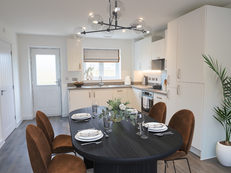 Interior CGI representation of a kitchen area with dining table and chairs taken in an actual 3 bed house at Benson Grange