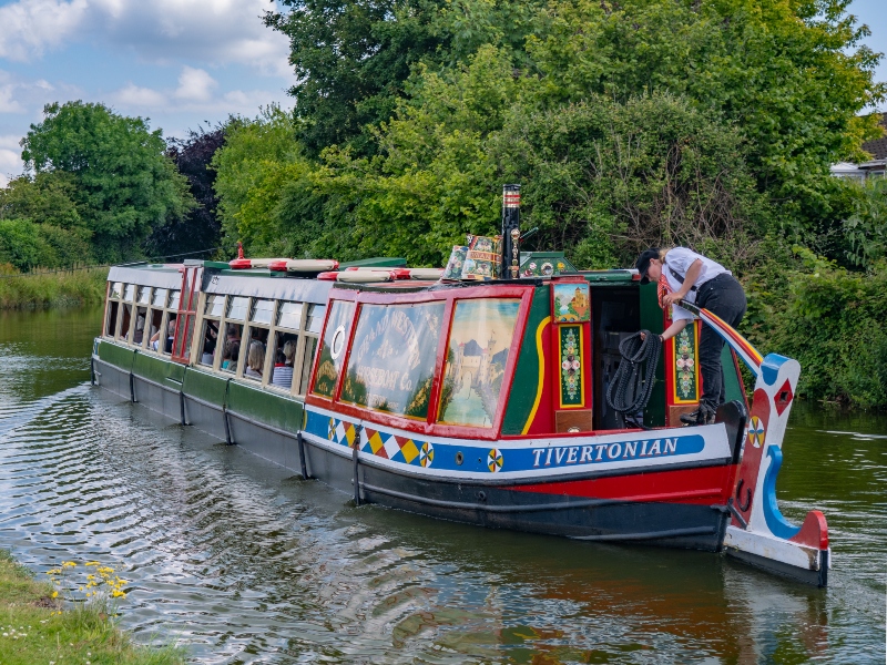 Colourful barge being sailed down the Grand Western Canal