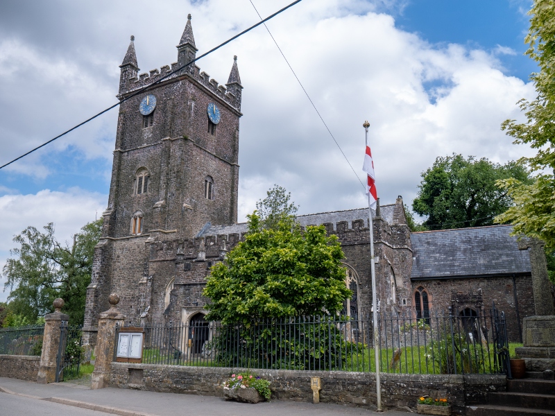 Exterior view of the St John the Baptist church in Witheridge, showing the main bell tower