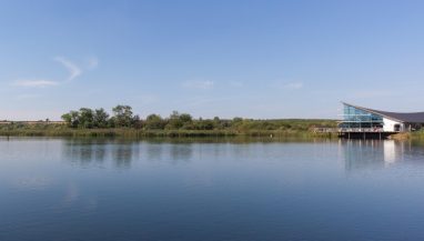 Exterior view across Stanwick lake with building on the bank