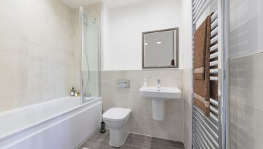 Image is a CGI representation of the bathroom in the actual Plot 24, Two Bed Shared Ownership Apartment at Woodside Grove, Bagshot, from Legal & General Affordable Homes