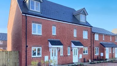 Exterior photo of two townhouses with driveway of the Shared Ownership house style at Oakcroft Chase, Hampshire