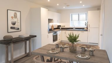 Interior CGI representation of a kitchen area with dining table and chairs taken in an actual 4 bed house at Benson Grange