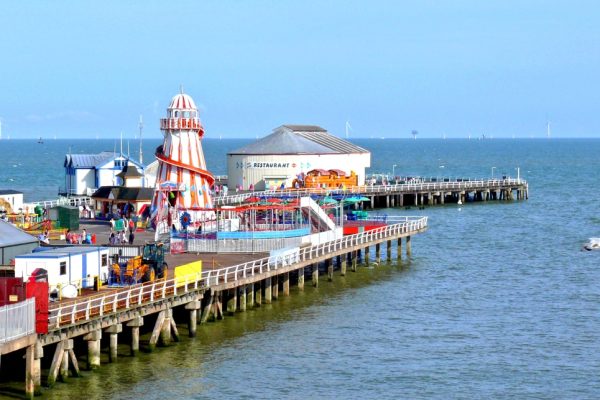 Clacton Pier from land on sunny day featuring seagulls.